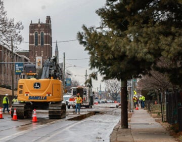 Workers dig up the street to fix the gas leak.