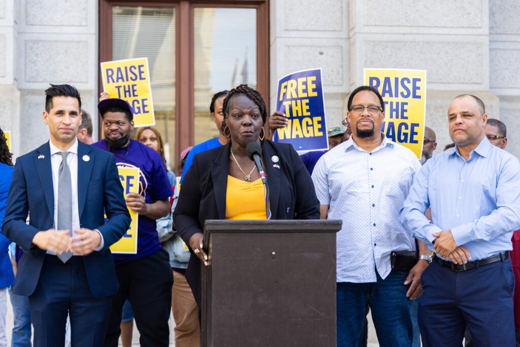 Roni Green speaking at a podium at the rally
