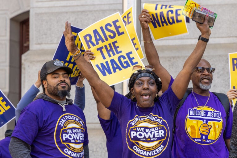 Union members at the rally holding signs saying 