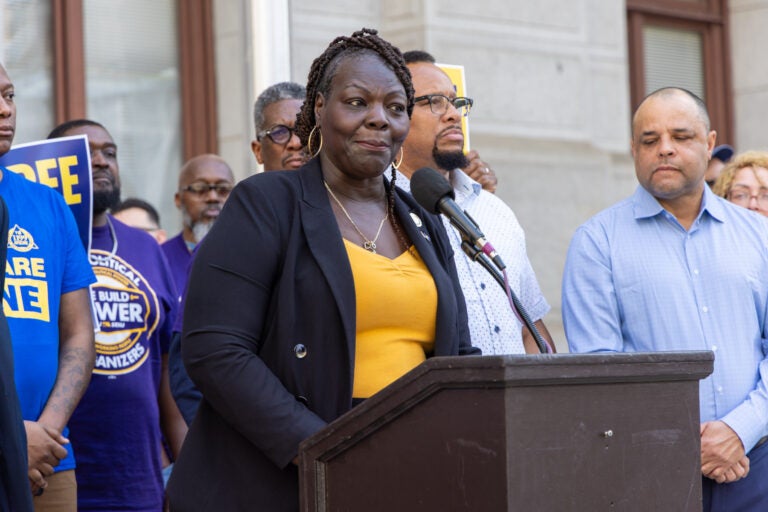 Roni Green speaking at a podium at the rally
