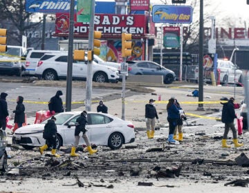Investigators on the ground at the site of the plane crash