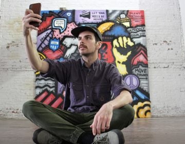 Conrad Benner takes a selfie in front of Alloyius Mcilwaine's 