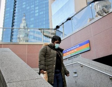 A rider descends the stairs to the 15th Street subway station, across the street from City Hall. (Emma Lee/WHYY)