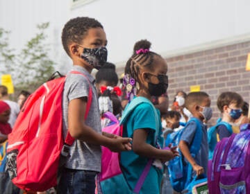 Students wear face masks outside of their school in Philly