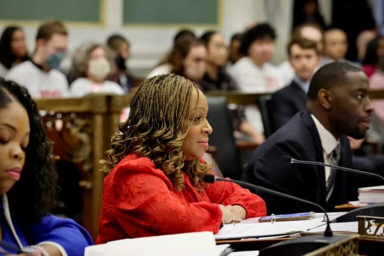 Jamie Gauthier sits in front of a microphone