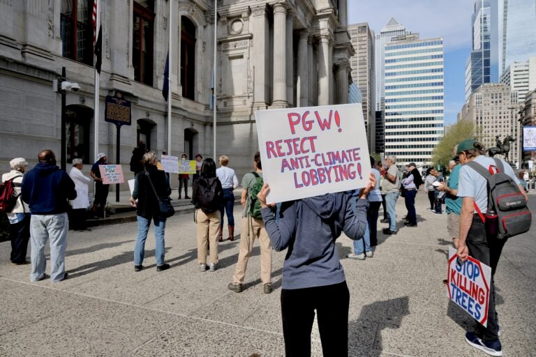 a sign reads PGW! REJECT ANTI-CLIMATE LOBBYING!