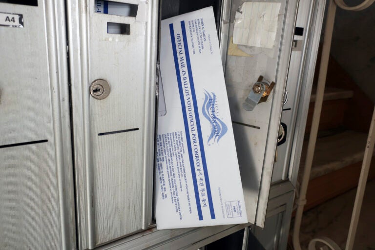 A mail ballot is positioned in a mailbox