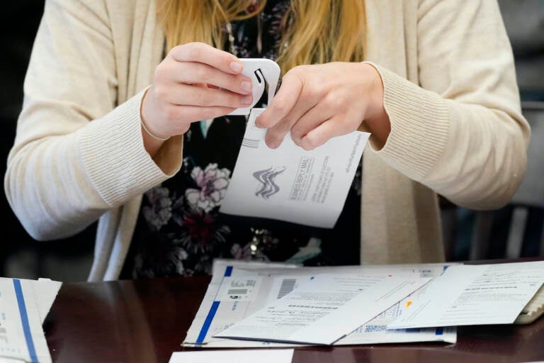 A Luzerne County worker canvases ballots that arrived after closing of voting until Friday at 5 p.m. and postmarked by Nov. 3rd as vote counting in the general election continues, Friday, Nov. 6, 2020, in Wilkes-Barre, Pa.