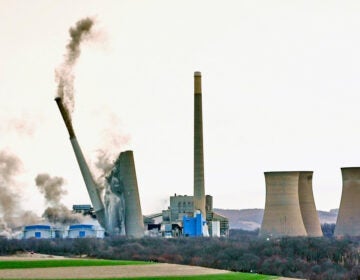 The smokestacks of the former coal-fired Homer City Generating Station crumble in a planned demolition