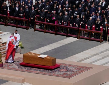 Pope Francis is wheeled through the Vatican in a coffin in front of a crowd