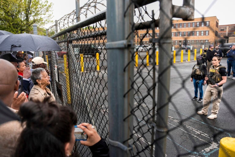 Rep. Bonnie Watson Coleman, D-N.J., speaks with an officer demanding she be let into the ICE Detention office