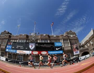 A view of runners running around a track.