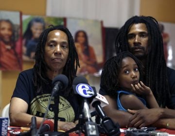 Debbie Africa, (left), participates in a news conference alongside her son Michael Africa, Jr. and granddaughter Alia, 6, Tuesday June 19, 2018, in Philadelphia. Africa, a member of the radical group MOVE, was released from prison on Saturday, nearly 40 years after the group engaged in a shootout that killed a Philadelphia police officer in 1978. Michael Africa, Sr., has now also been released.  (Jacqueline Larma/AP Photo)