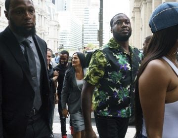 Rapper Meek Mill, (center), arrives at the Criminal Justice Center in Philadelphia on Tuesday, Aug. 27, 2019.  (Jessica Griffin/The Philadelphia Inquirer via AP)