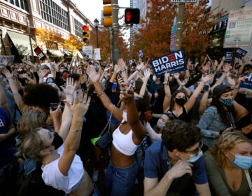 People dance as they celebrate outside the Pennsylvania Convention Center