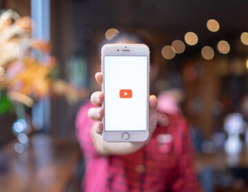 CHIANG MAI, THAILAND - Apr.08,2019: Woman holding Apple iPhone 6S Rose Gold with Youtube apps on screen. YouTube is the popular online video sharing website.