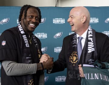 Gianni Infantino and A.J. Brown shaking hands at the press conference