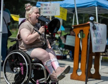 Natalie Kolander speaks into a megaphone