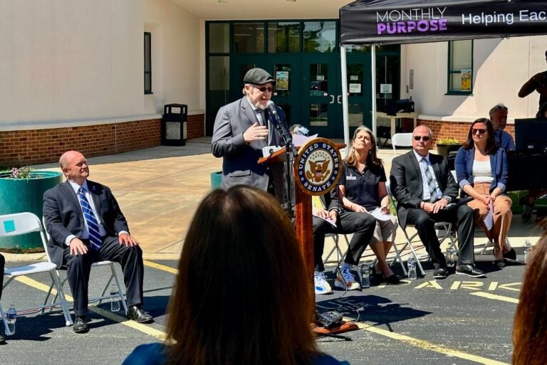 Daniel Elkin speaking at a podium at the press conference
