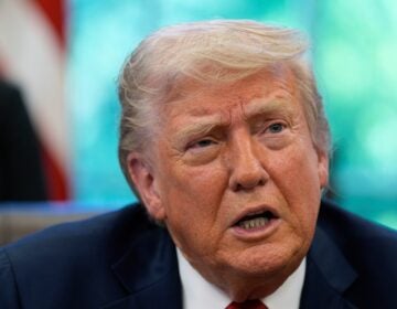 Donald Trump speaks with reporters