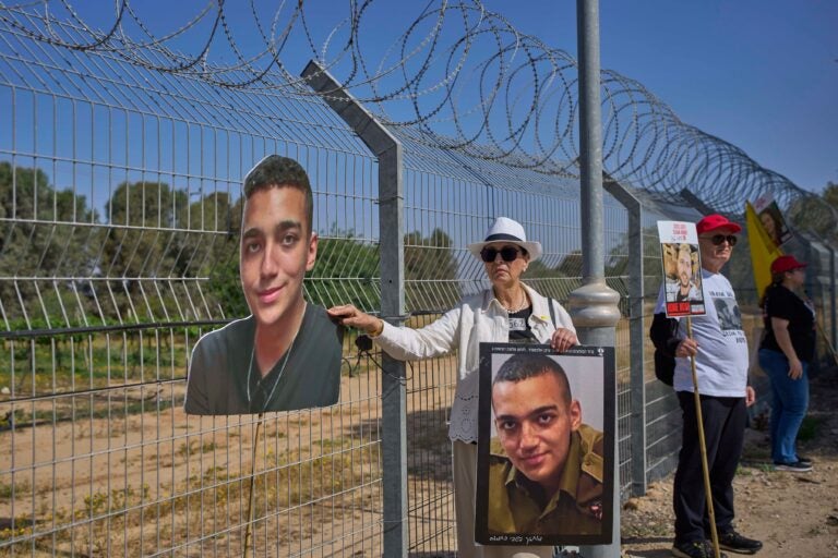 Varda Ben Baruch holds a picture of her grandson Edan Alexander near the Gaza border in Kibbutz Nir Oz