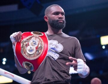 Jaron Ennis holding his championship belt