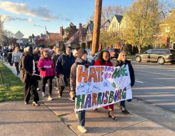 People walk during a march and prayer vigil in Harrisburg, Pa.