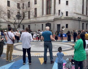 people in a circle at the event in the City Hall courtyard