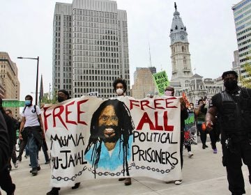 Protesters take to the streets to demand freedom for Mumia Abu Jamal. (Emma Lee/WHYY)