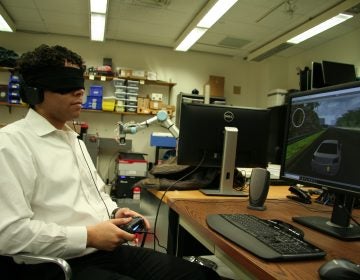 Brian Smith plays a racing game blindfolded. He made a user interface for blind players to drive in video games, just like sighted players. He tested it with blind volunteers, as well as blindfolded sighted volunteers.