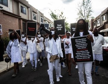 Social justice organizers and surviving members of the MOVE family march down the 6200 block of Osage Avenue on May 13, 2021. (Kimberly Paynter/WHYY)