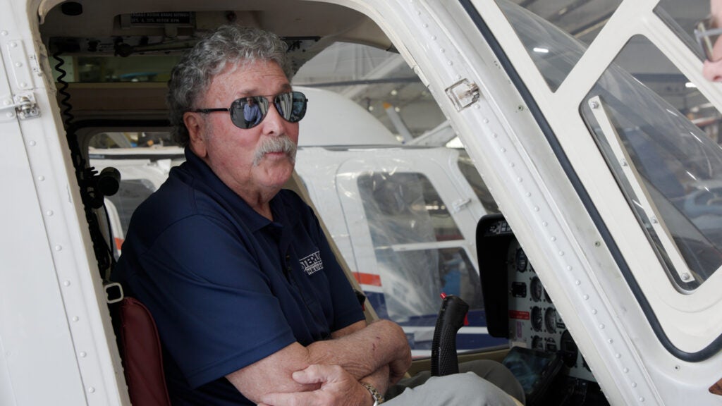 Mark Ciccone sits in a helicopter