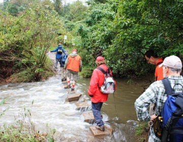 Hikers crossing the Wissahickon creek