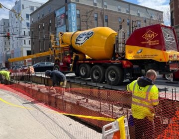construction workers and a cement truck at a construction site