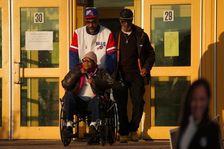 Liza Fortt, 74 (center), accompanied by her son Timothy Walker (center top), and husband Willie Fortt emerge from their polling place at Scranton High School on Election Day, Nov. 5, 2024.