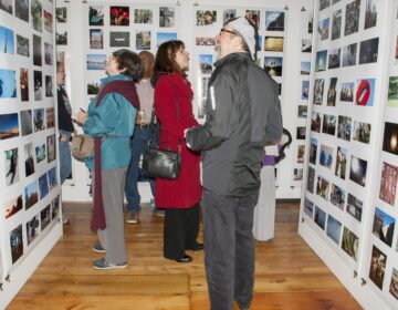 People admiring photographs at an exhibition