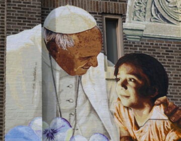 Mural of Pope Francis and child on the facade of Saint Malachy School