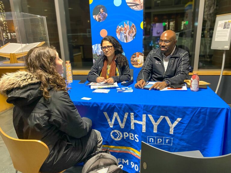 WHYY's pop-up newsroom at Princeton Public Library. Madhu Bora and P. Kenneth Burns speak with an attendee