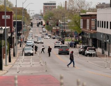 People cross 31st Street in Kansas City, Mo.