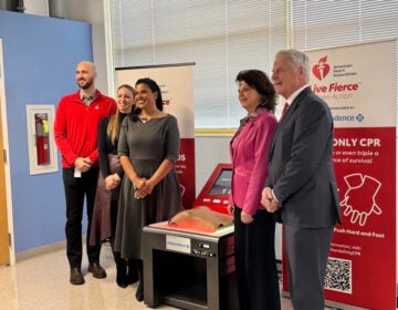 Brenda Robles-Cooke (middle left) poses with other officials next to the new Spanish-speaking CPR training device