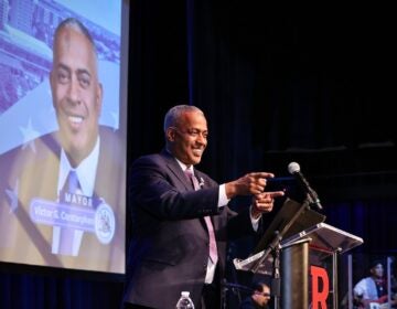Camden Mayor Vic Carstarphen on stage at Gordon Theater
