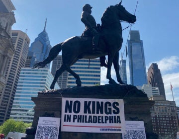 a sign on a City Hall monument reads NO KINGS IN PHILADELPHIA