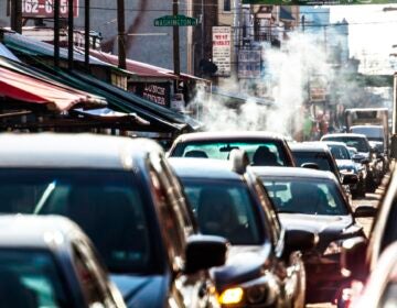 Cars sitting in traffic on a busy street
