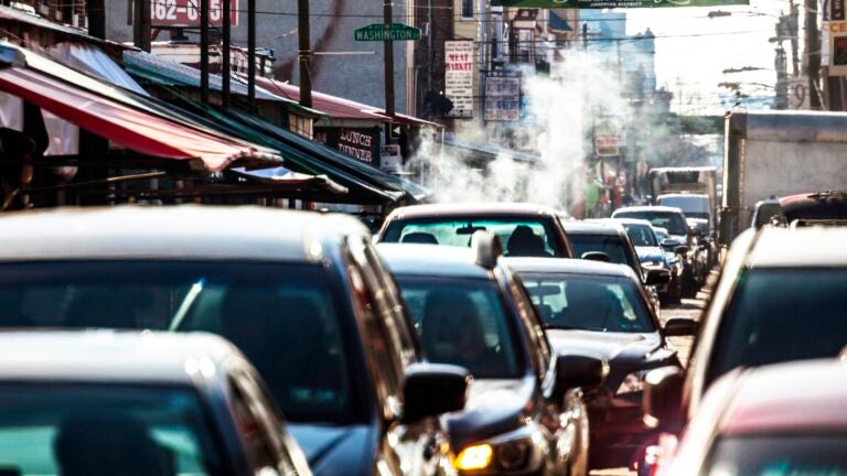 Cars sitting in traffic on a busy street