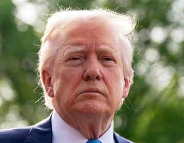 President Donald Trump speaks with reporters