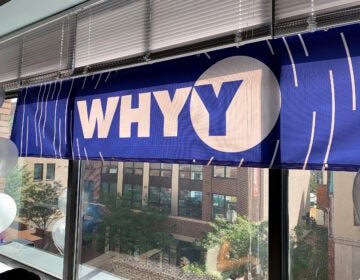 WHYY banner hanging in a window of an office