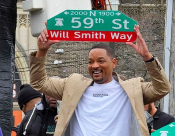 Will Smith holds the Will Smith Way sign