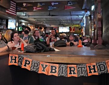 People watching sports on tvs at a bar
