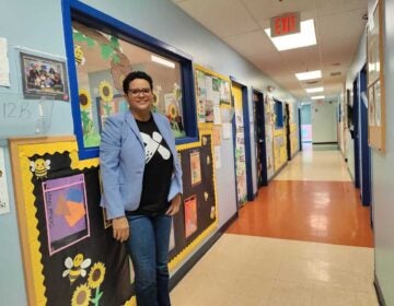 Dr. Michelle Carerra Morales poses for a photo in a hallway