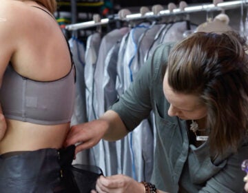woman making adjustments to clothing